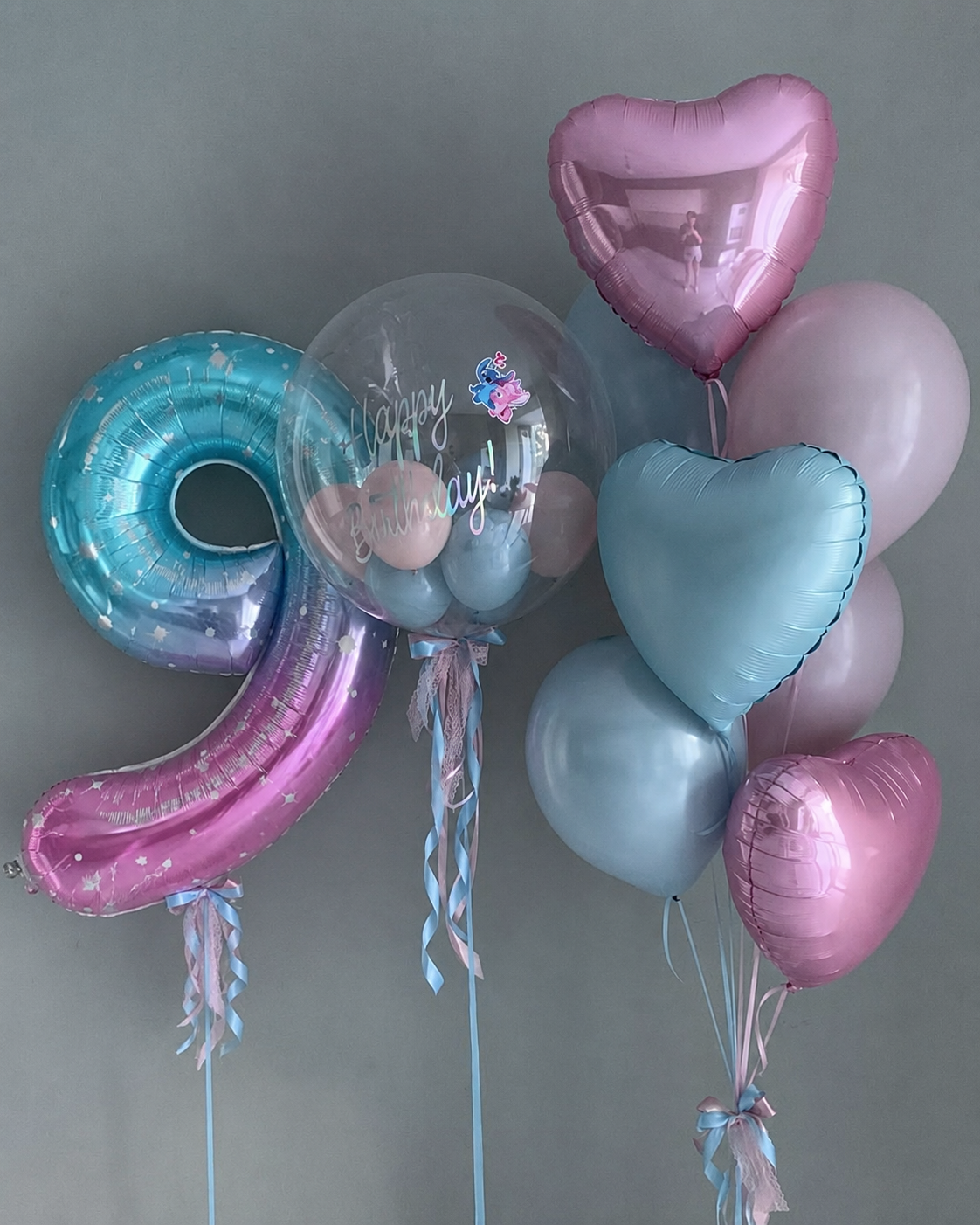 Close-up of blue pink ombre number 9 foil balloon with star detail