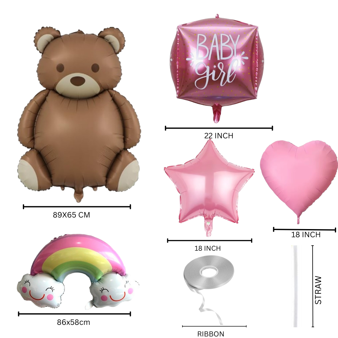 Baby girl celebration setup with large teddy bear balloon, pink star and heart foil balloons, rainbow with smiling clouds, and a newborn baby wrapped in pink — perfect for baby shower or photo backdrop.